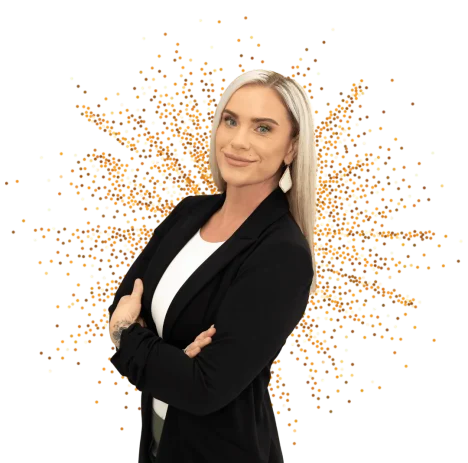 Professional Beauty Consultant Confident professional woman smiling with arms crossed in front of a festive background.