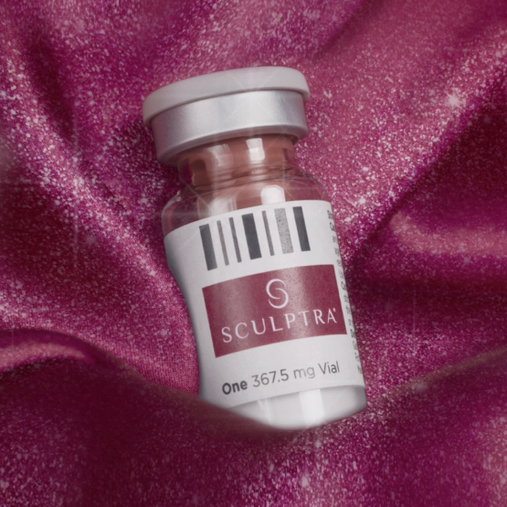 Rejuvenate Your Skin with Sculptra Sculptra vial placed on a textured pink background, highlighting the product's effectiveness.