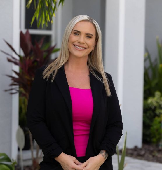 Rejuvenate Your Look with Advanced Treatments Beauty professional standing outside in a black blazer and pink top.